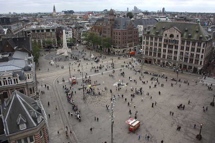 Dam Square seen from the roof of the Nieuwe Kerk, with the National Monument and people crossing the square.